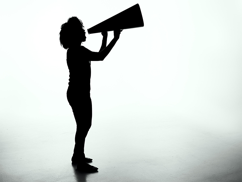 silhouette of a woman holding a megaphone