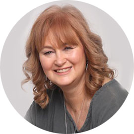 person with long hair smiling