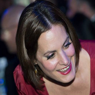 side on view of woman in a red dress smiling