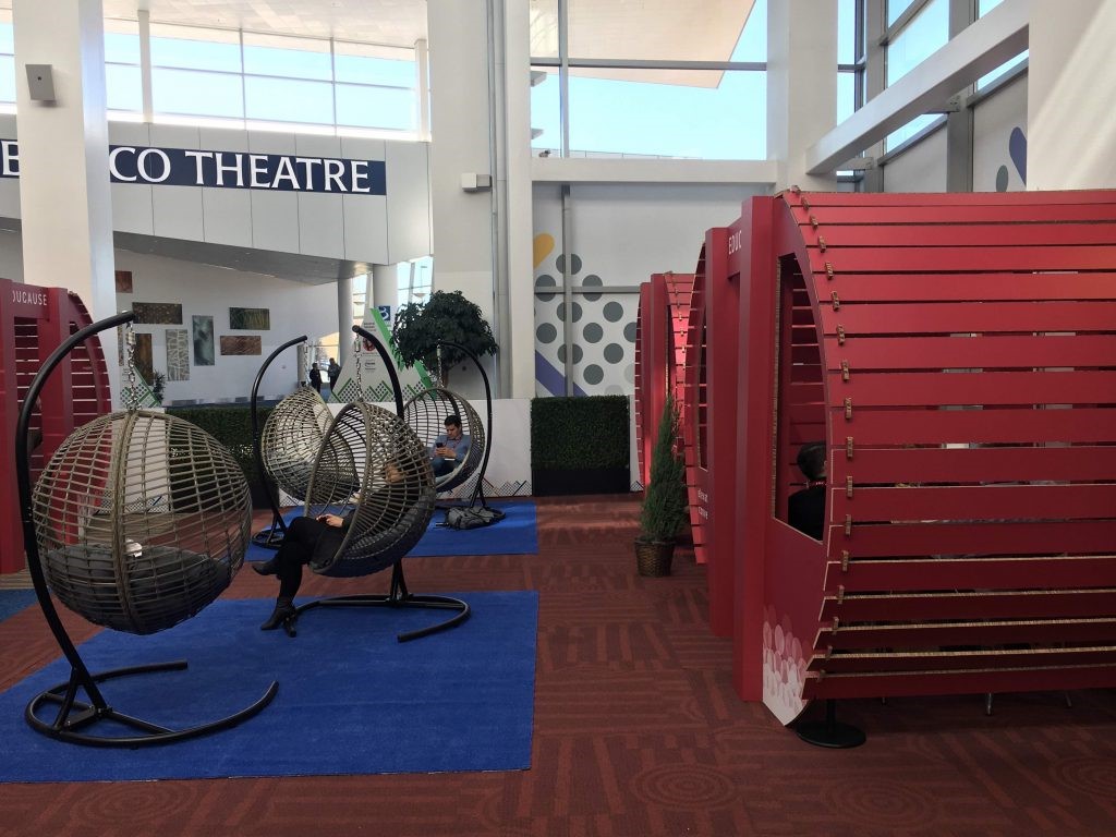 Photograph of Educause 18 Braindate seating of corrugated cardboard booths and swing seating