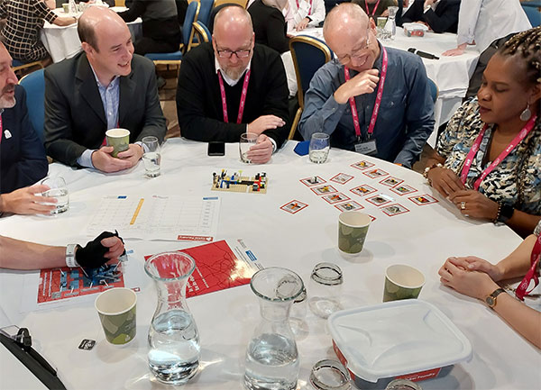 a group of people at a conference learning with Lego